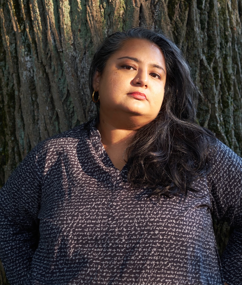 Roohi standing in front of a tree